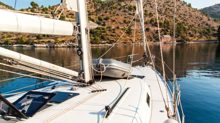 Sail boat on the water looking at shore line